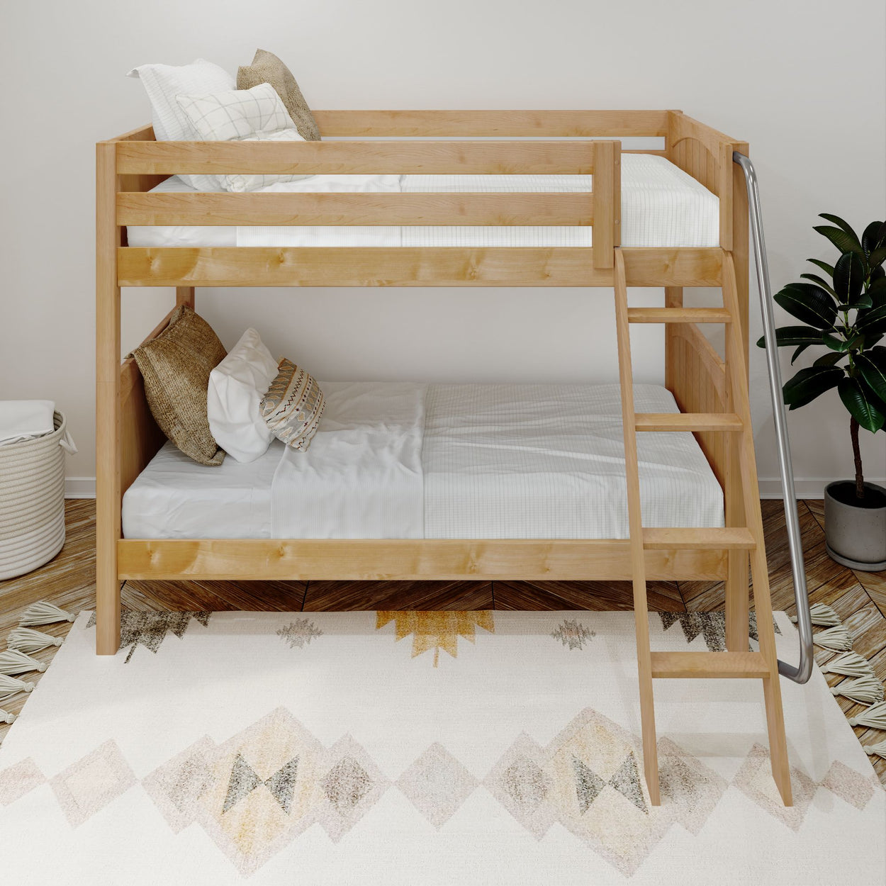 Wooden bunk bed with white bedding and decorative pillows in a modern bedroom setting with a rug and plant.