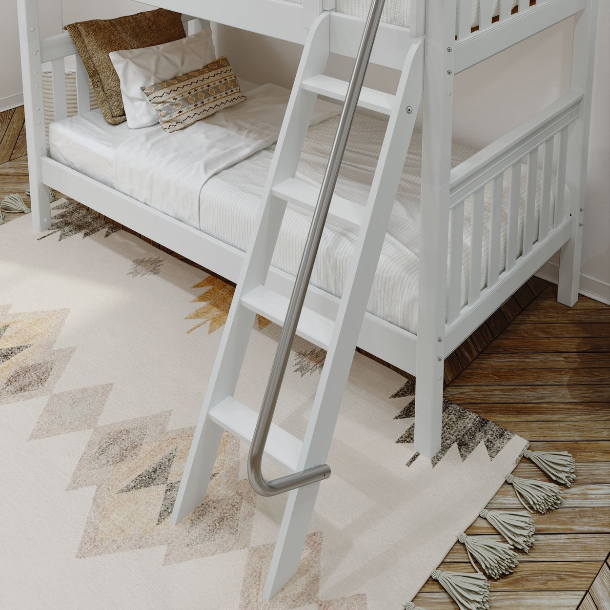 White wooden bunk bed with ladder and decorative cushions on geometric-patterned rug.