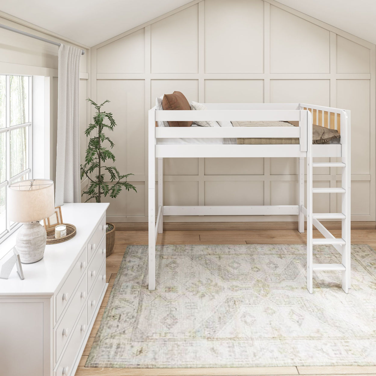 Loft bed in modern bedroom with white furniture and natural light.