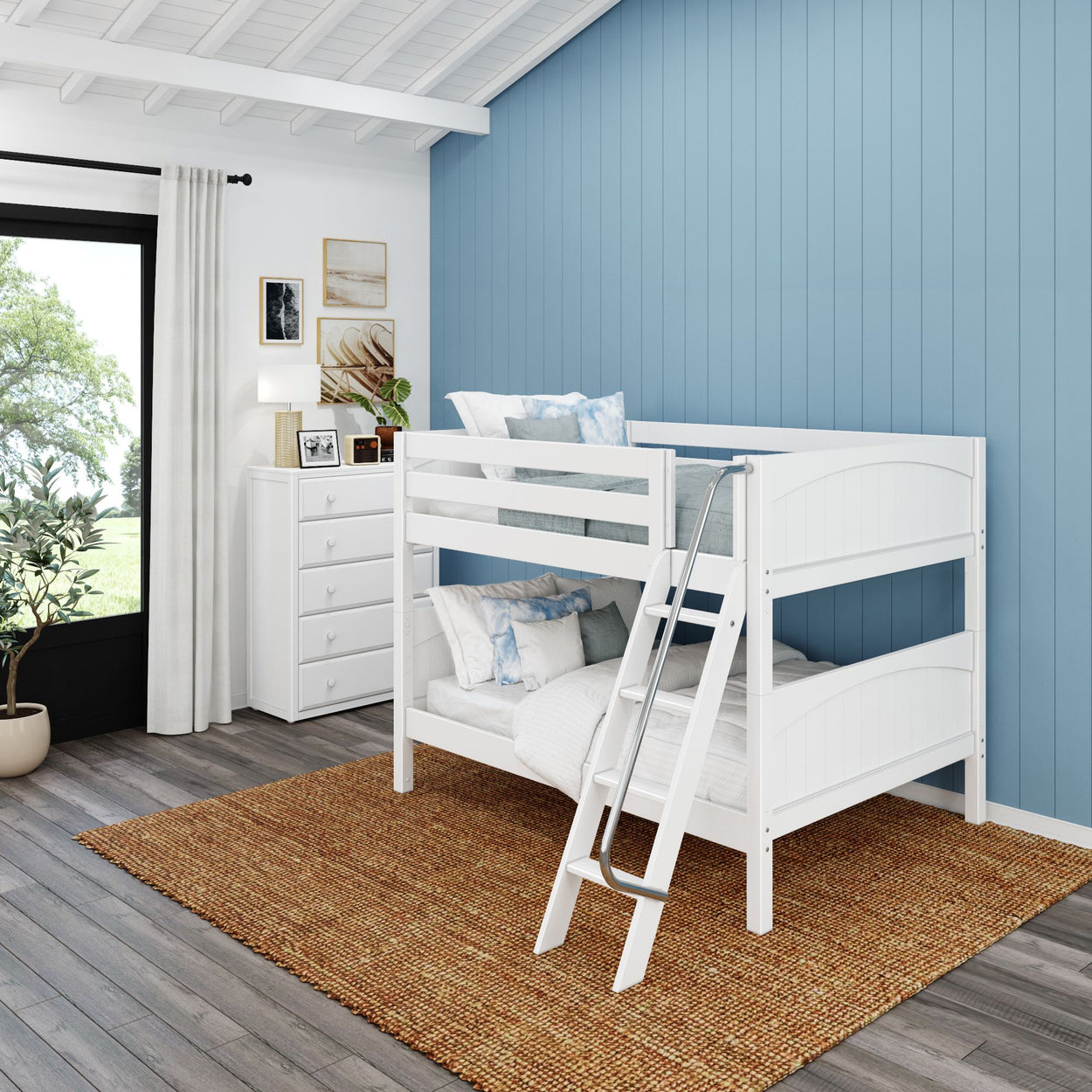 White wooden bunk bed with ladder in blue-themed bedroom featuring wooden floor, woven rug, and natural light from large window.