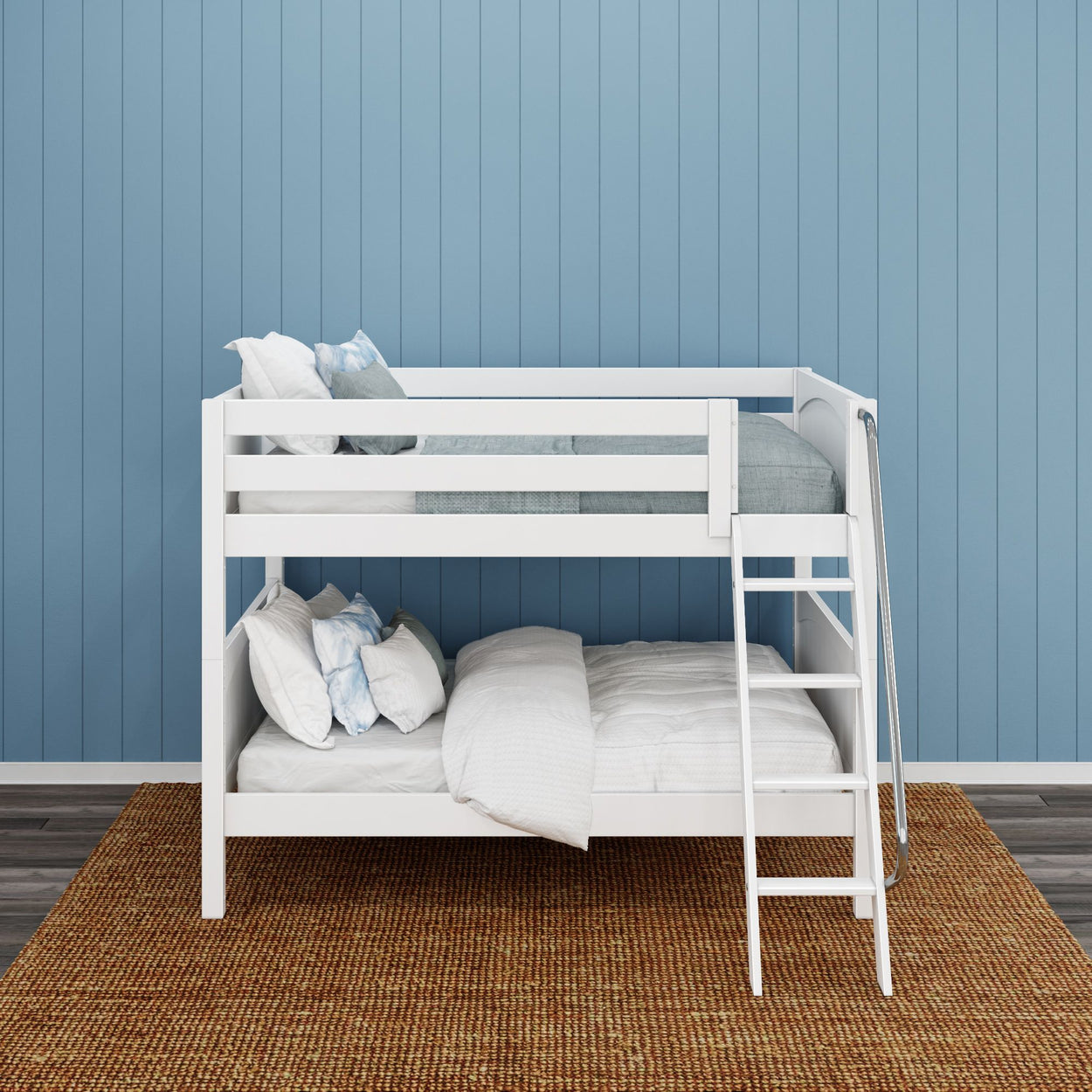 White bunk bed with cozy bedding against a blue paneled wall in a stylish kid's room.