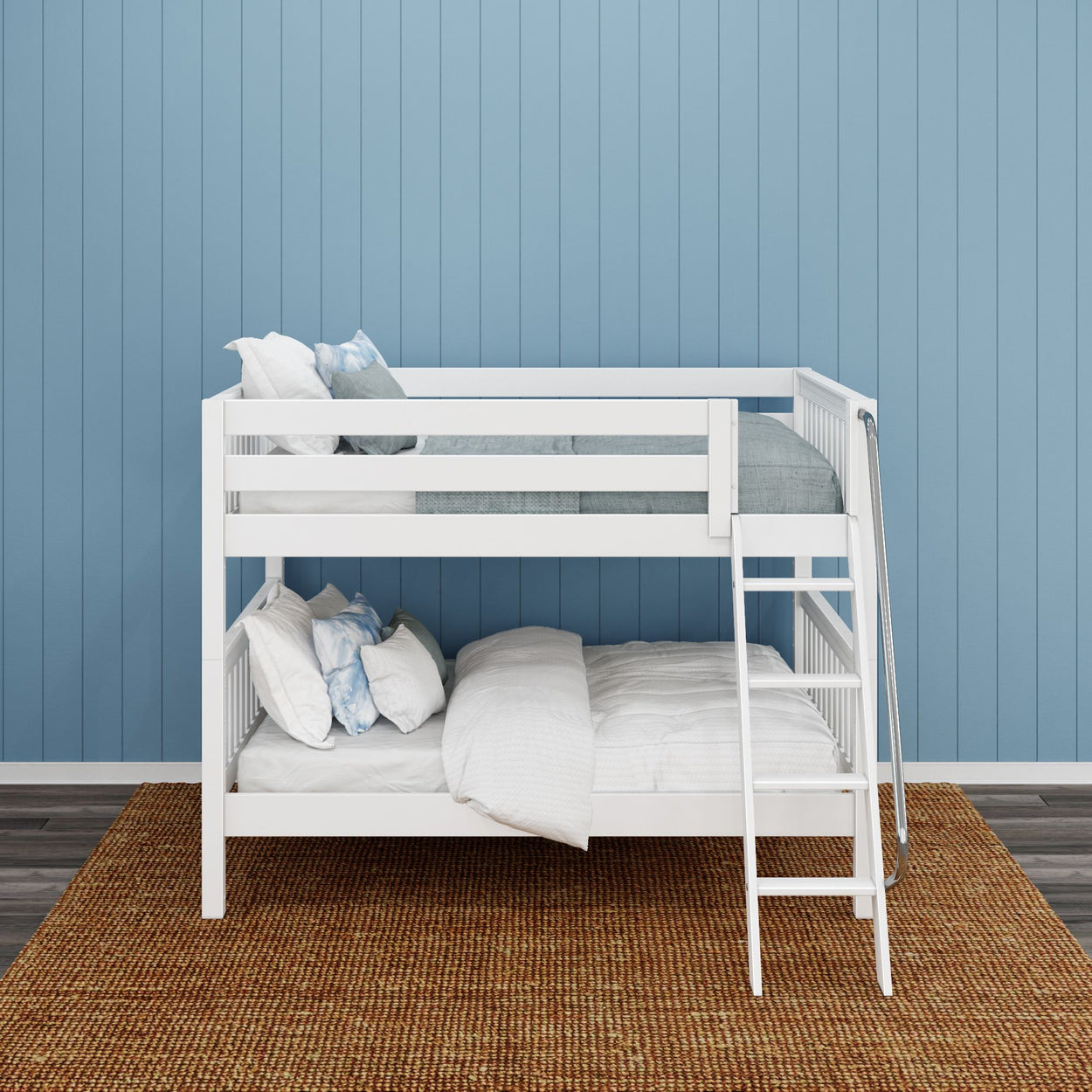 White wooden bunk bed against a blue paneled wall with a woven rug on floor.