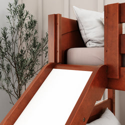 Wooden bunk bed with slide next to a potted plant in a modern bedroom setting.