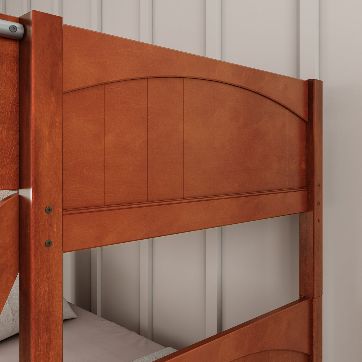 Wooden bunk bed close-up against a textured wall.