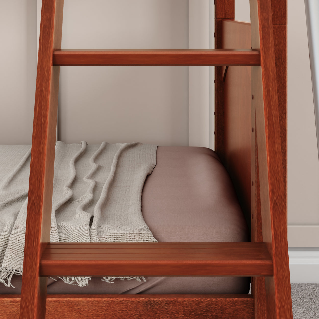 Wooden bunk bed ladder next to neatly arranged blanket and mattress in a cozy bedroom setting.