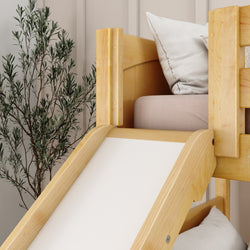Kids' room with wooden slide bed and cozy pillows near a decorative plant.