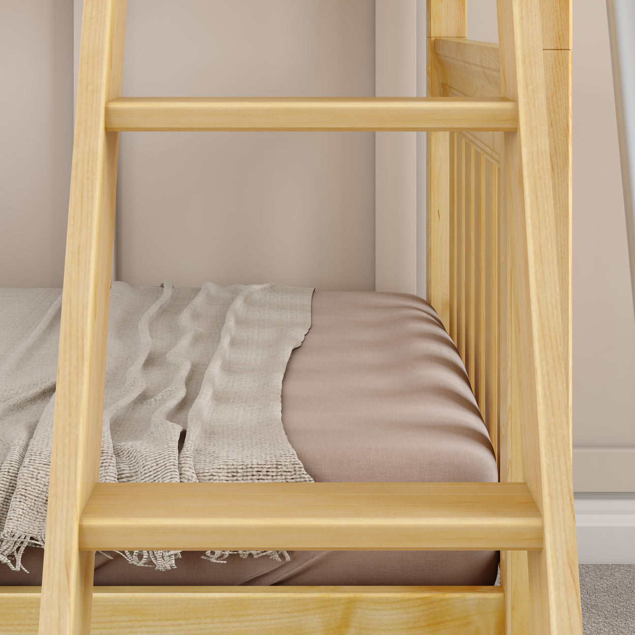 Wooden bunk bed with cozy beige bedding and decorative fringed throw blanket in a minimalist bedroom.