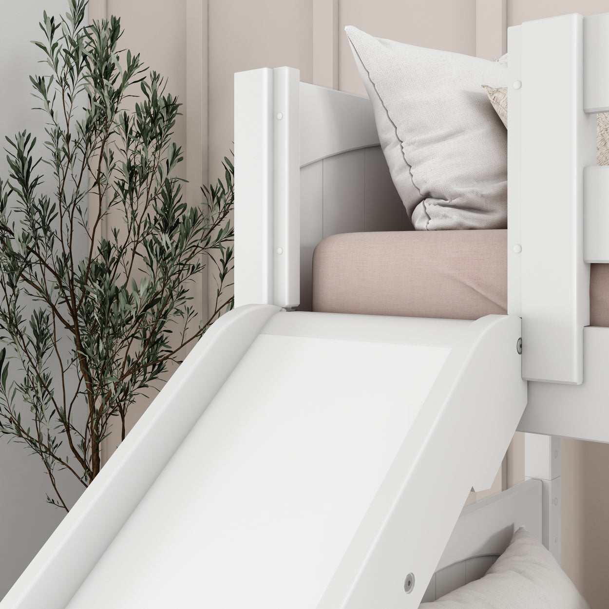 White wooden bunk bed with slide, cozy pillows, and indoor plant for a modern kids' bedroom design.