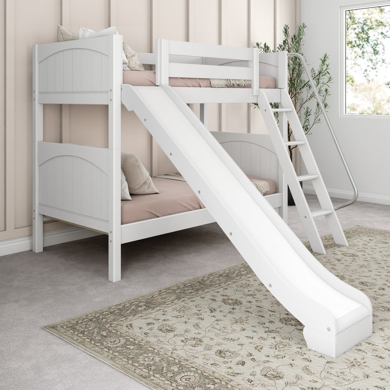 White wooden bunk bed with slide and ladder in a cozy children's bedroom with a soft carpet and decorative pillows.