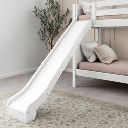 White bunk bed with slide and beige bedding in a modern children's bedroom with decorative plant.