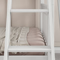 White wooden ladder and guardrails on a modern neutral-toned loft bed with beige mattress and textured throw blanket