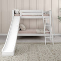 White wooden bunk bed with slide and ladder in a neutral kids' bedroom with blush bedding, pillows, woven throw and patterned rug