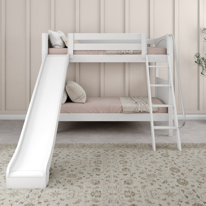 White wooden bunk bed with slide and ladder in a neutral kids' bedroom with blush bedding, pillows, woven throw and patterned rug