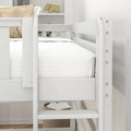 White wooden bunk bed close-up with safety rail, white striped bedding, woven jute pillow, wooden elephant decor and woven storage basket in a minimalist kids bedroom