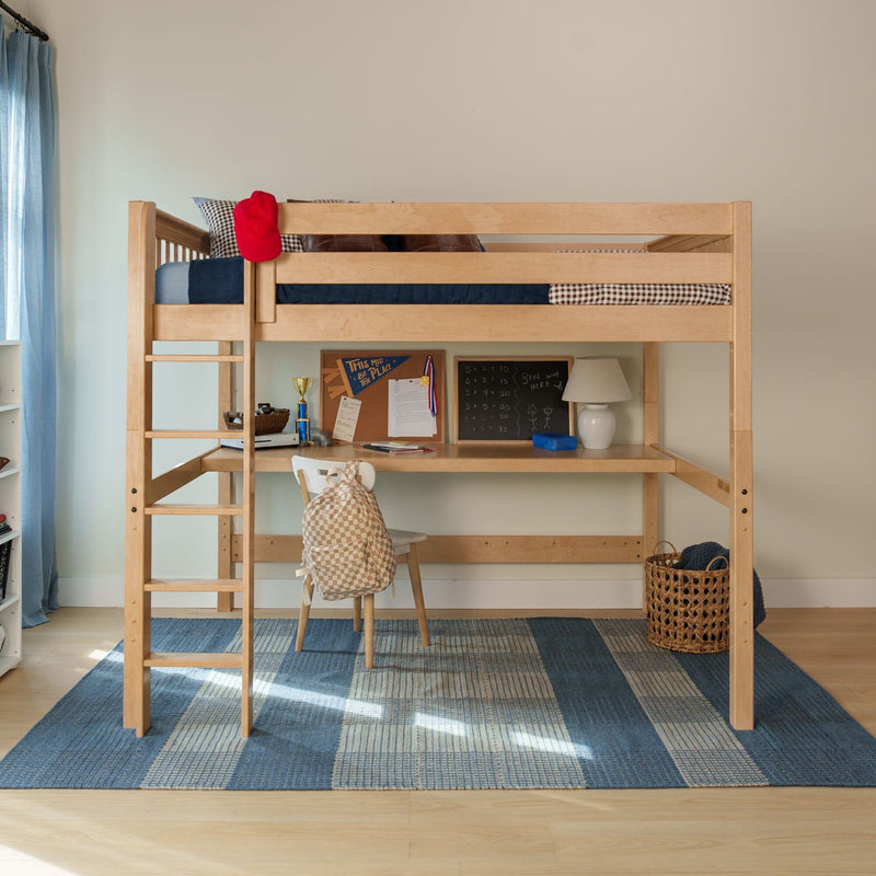 Wooden loft bed with built-in desk and ladder in children's bedroom, blue patterned rug, chair with checkered backpack, corkboard, lamp and red hat on rail
