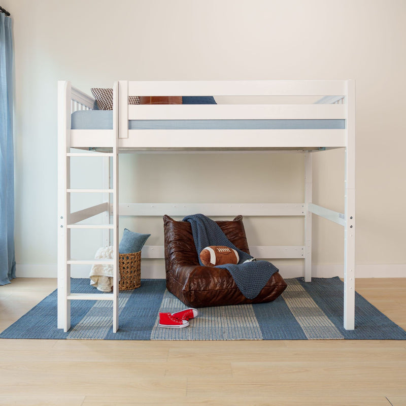White wooden loft bunk bed with ladder, blue bedding and pillows, leather floor chair, football toy, wicker basket and red sneakers in a modern kids' bedroom