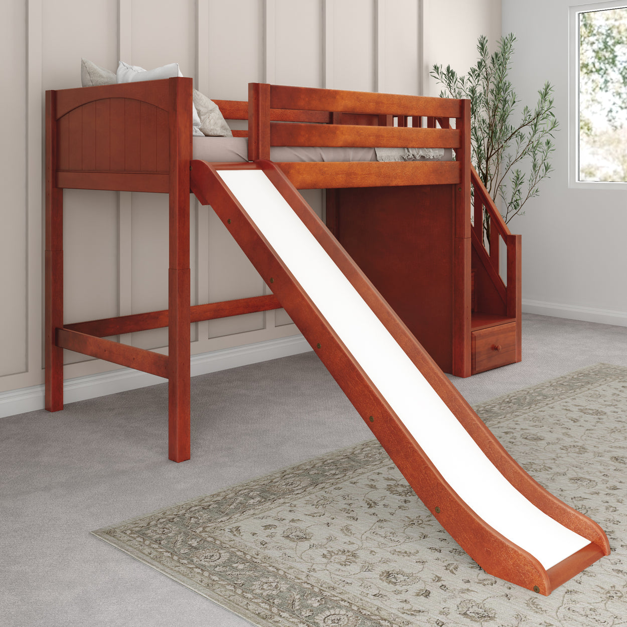 Children's wooden loft bed with slide and ladder in cozy bedroom setting.