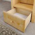 Open light maple dresser drawer with round wooden knob on beige carpet, empty bedroom storage drawer