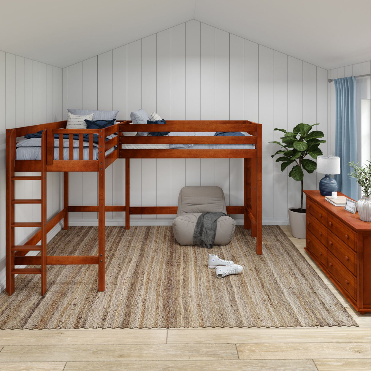 Loft bed in a cozy bedroom with wood flooring and furniture, featuring a soft armchair and decorative plants for a comfortable and stylish space.