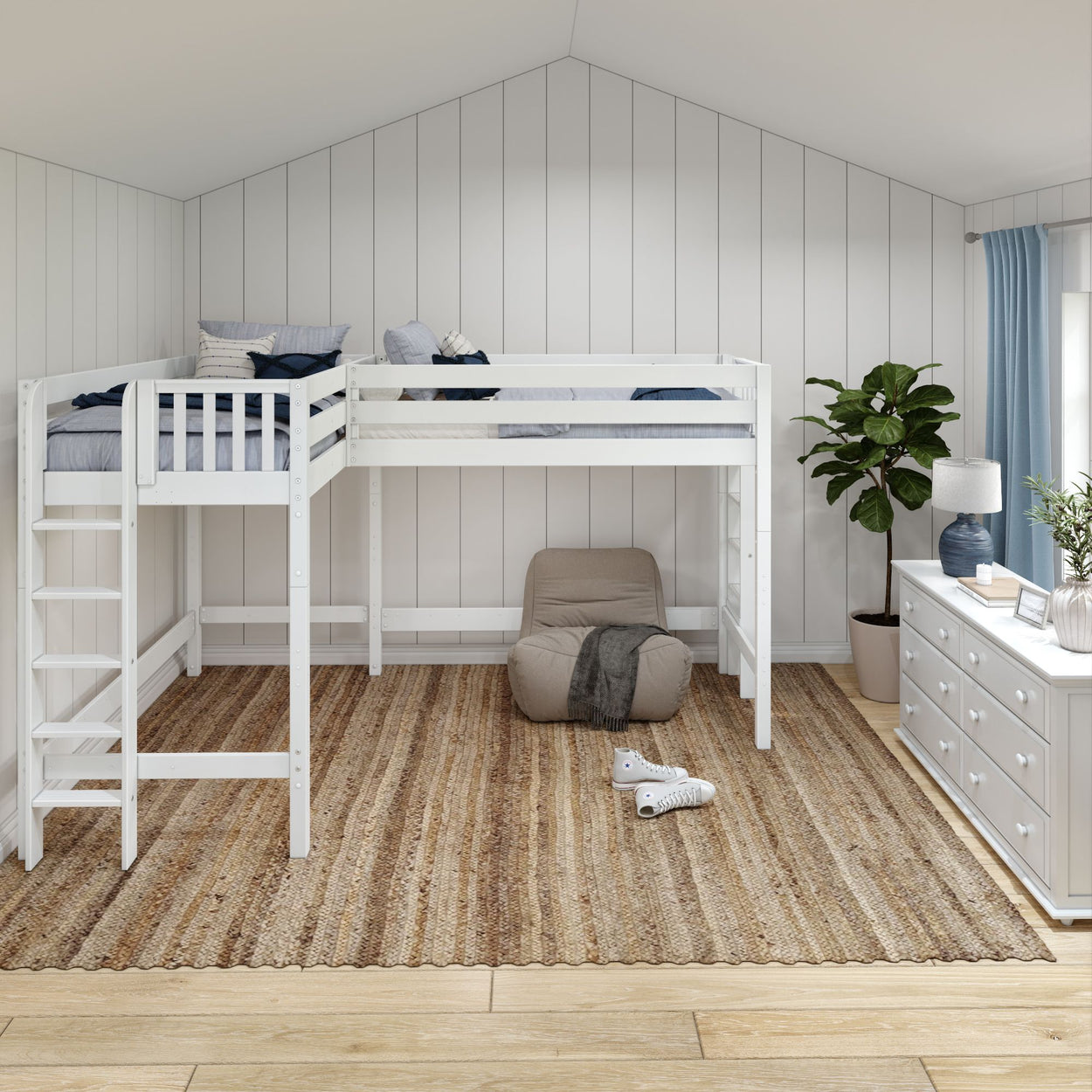 Modern kids' loft bedroom with white bunk bed, cozy chair, dresser, and indoor plant in a bright, airy space.