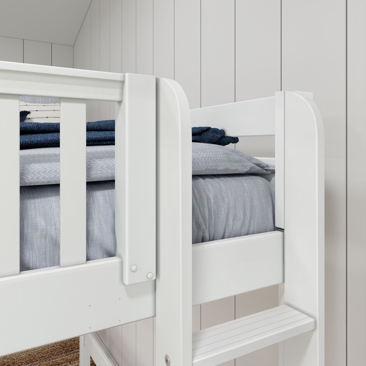 White bunk bed with blue bedding and wooden panel wall background.