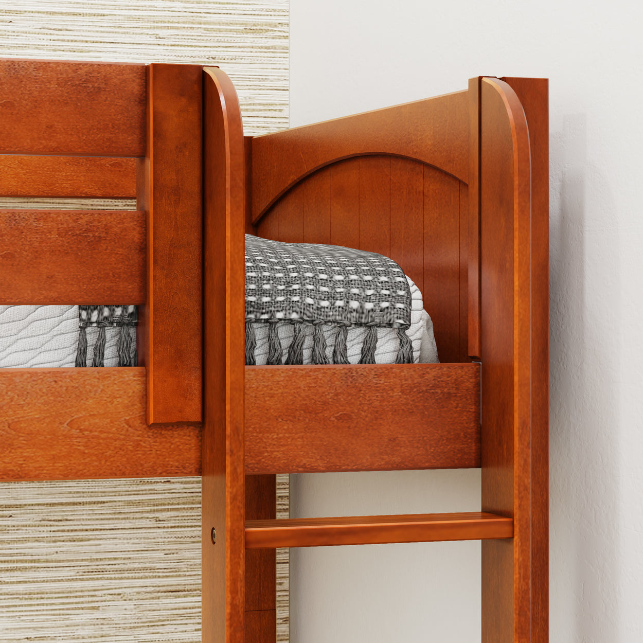 Wooden bunk bed frame with cozy bedding and intricate headboard design.