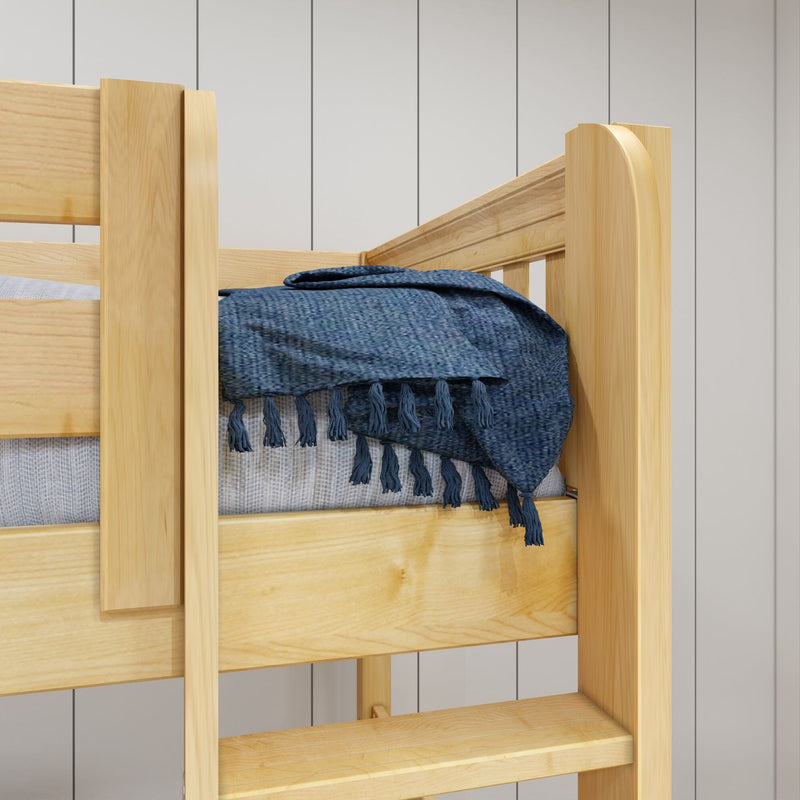 Close-up of natural pine bunk bed rail with textured navy blue woven throw and tassels against white shiplap wall