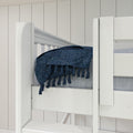 White wooden bunk bed with railing, navy blue tasseled throw blanket and gray mattress against white shiplap wall