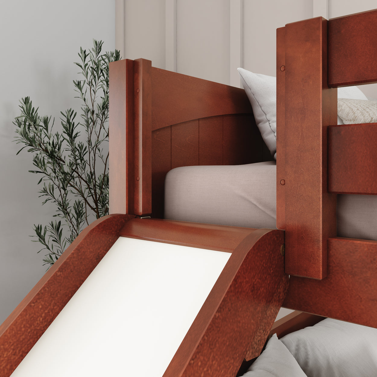 Wooden bunk bed with slide and cushions in modern bedroom.