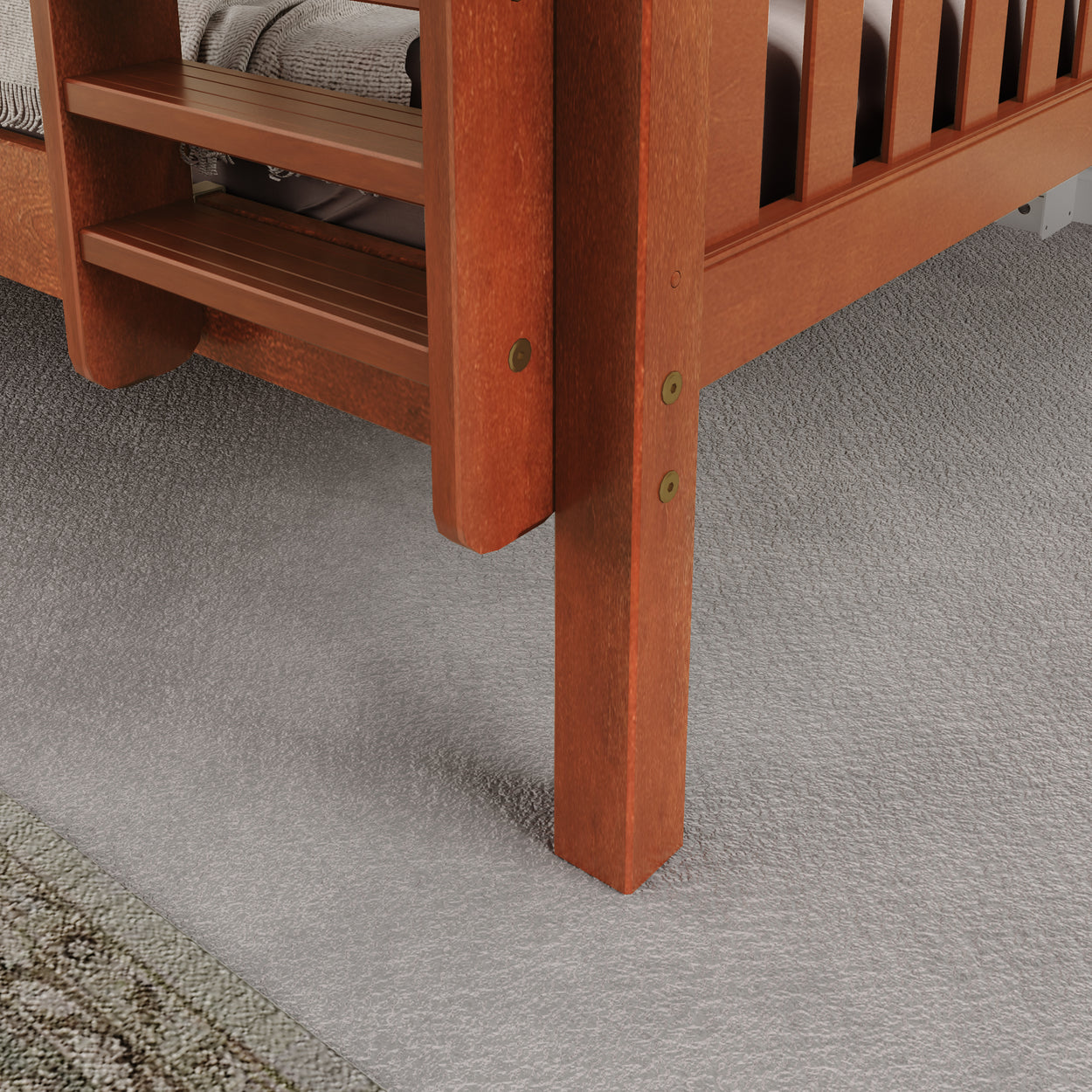Wooden bunk bed ladder close-up on gray carpet flooring in bedroom.