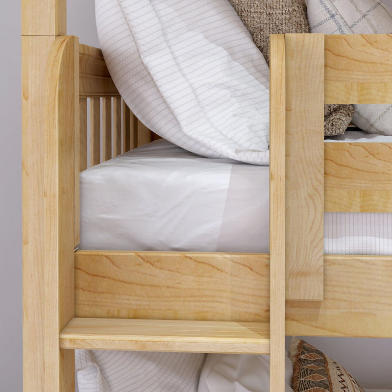 Close-up of natural wood bunk bed frame and ladder with white striped bedding and neutral decorative pillows
