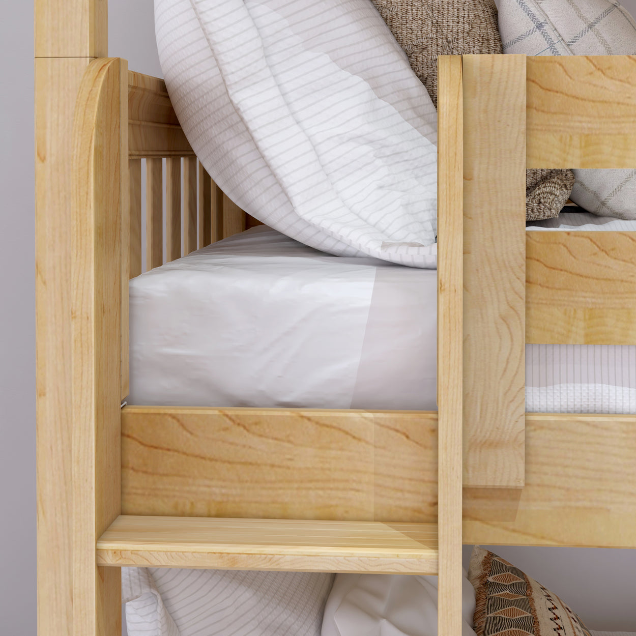 Natural wood bunk bed with white and beige striped bedding, featuring cozy pillows and a sturdy railing for a modern bedroom design.