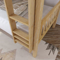 Close-up of natural pine wooden bunk bed ladder and slatted bed frame with beige checked bedding on hardwood floor