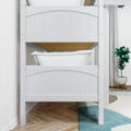 White wooden bunk bed with white bedding and pillow in a modern kids' bedroom, hardwood floor, teal area rug, potted plant and light gray curtains