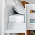 Close-up of white wooden bunk bed with white bedding, orange accent pillows and blue striped mattress in a modern kids' bedroom