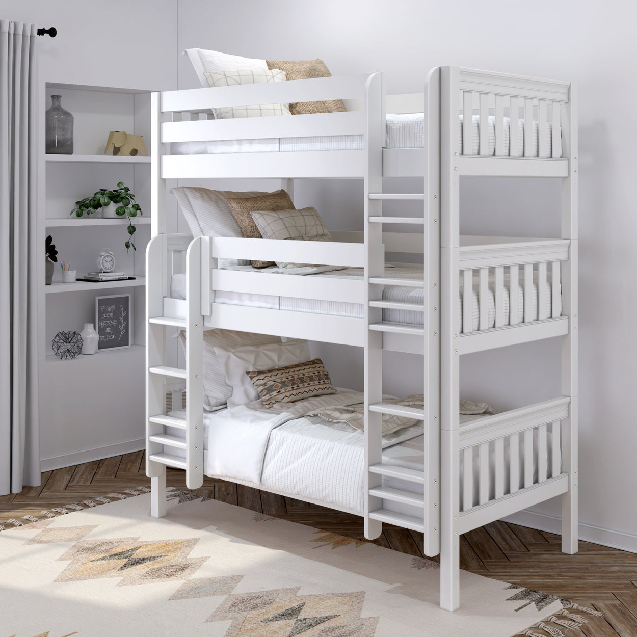 Modern white triple bunk bed in a stylish children's bedroom with cozy bedding and decorative pillows.