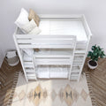 Top-down view of a white wooden bunk bed with neutral white bedding, beige and plaid throw pillows, ladder, woven storage basket, potted plant and patterned area rug in a minimalist kids' bedroom