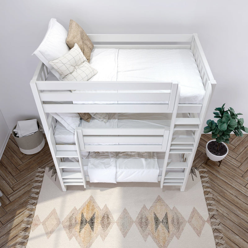 Top-down view of a white wooden bunk bed with neutral white bedding, beige and plaid throw pillows, ladder, woven storage basket, potted plant and patterned area rug in a minimalist kids' bedroom