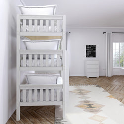 Modern white triple bunk bed with cozy pillows in a bright, minimalist bedroom featuring wooden floors and a geometric rug.