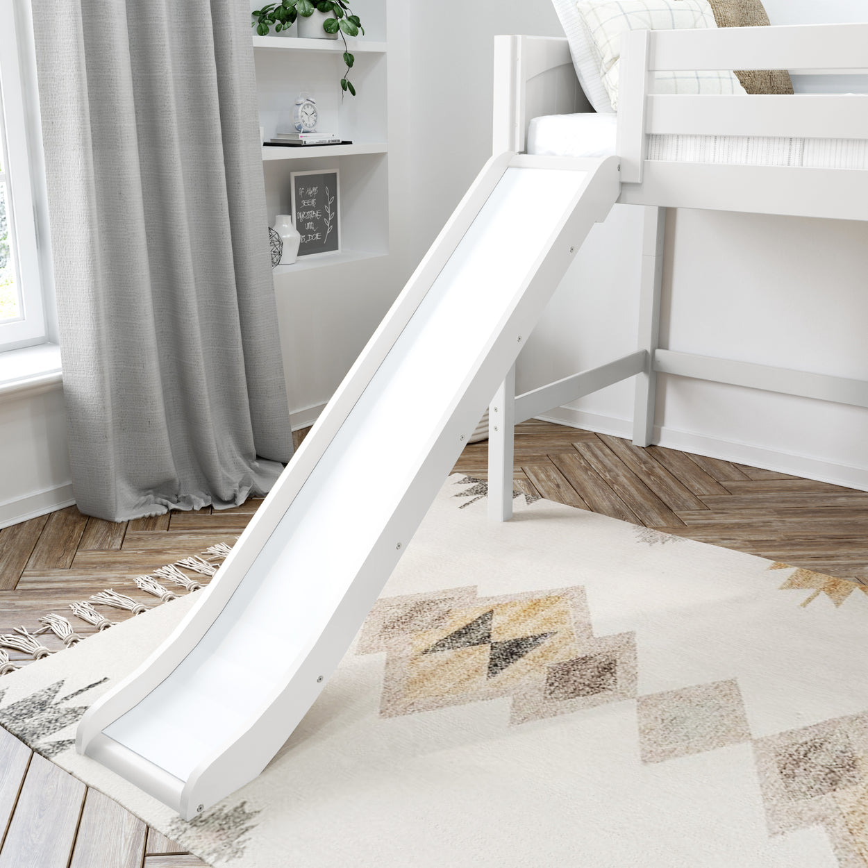White loft bed with slide in a modern kids' room with geometric rug and bookshelf.