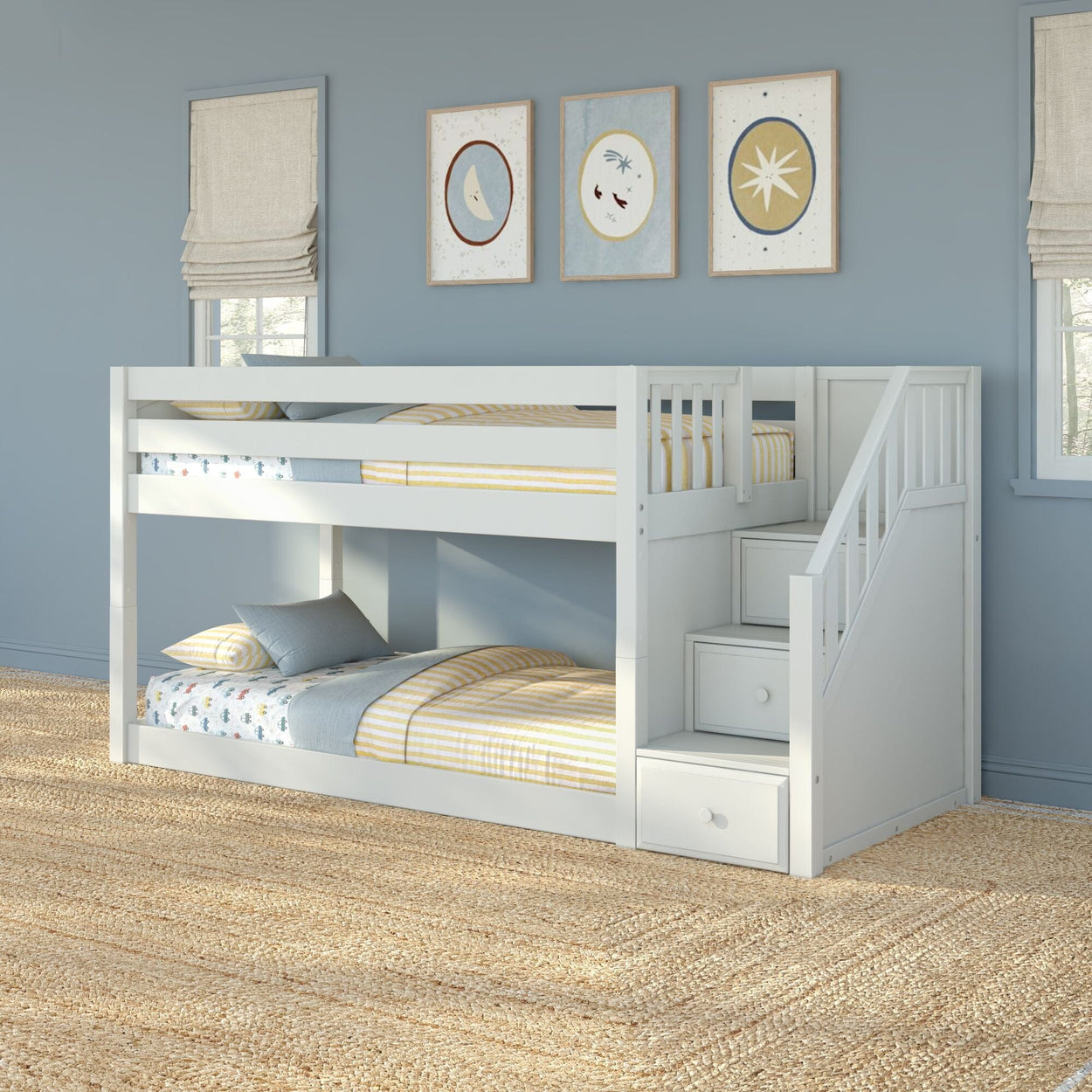 White twin-over-twin bunk bed with built-in storage stairs and drawers in a blue kids' bedroom with yellow-striped bedding and jute rug