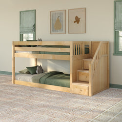 Natural maple twin-over-twin bunk bed with built-in storage stairs and drawers, green bedding and framed art in a cozy kids' bedroom