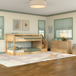 Natural wood twin-over-twin bunk bed with built-in staircase and green bedding in a kids' bedroom with coordinating six-drawer dresser, hardwood floors, area rug, and framed wall art