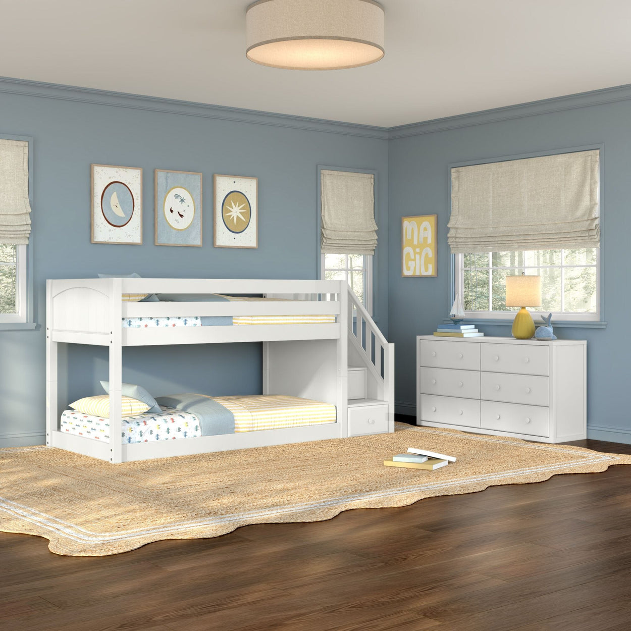 White wooden twin-over-twin bunk bed with stairs and storage in a modern blue kids' bedroom with white dresser, woven rug, and hardwood floor