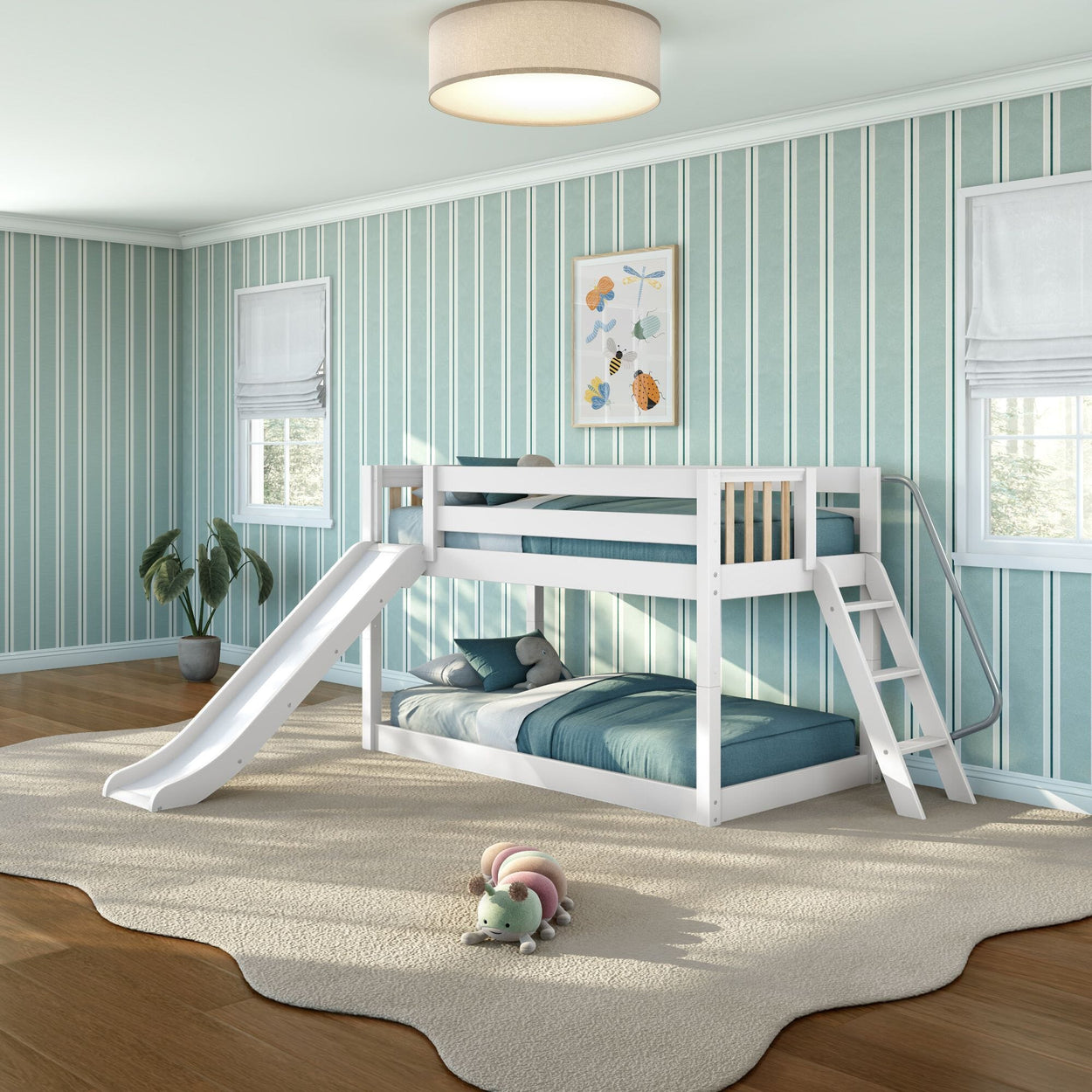 Modern white wooden bunk bed with slide and ladder in bright teal-striped kids' bedroom with area rug and plush caterpillar toy