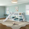 Bright modern kids' bedroom with white bunk bed and slide, teal striped wallpaper, cozy rug, plush toy, and natural light