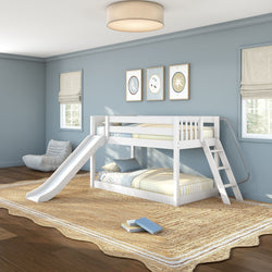 White twin-over-twin bunk bed with slide and ladder in a modern blue kids bedroom with striped bedding, natural jute rug, framed wall art, and large windows