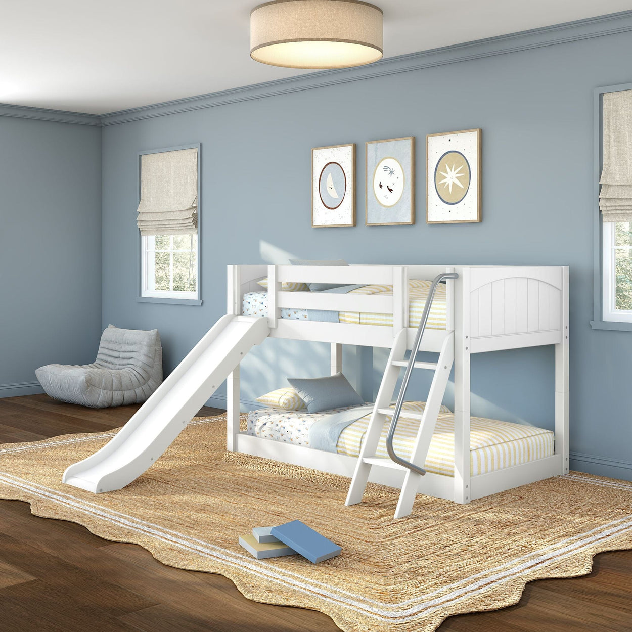 White twin-over-twin bunk bed with slide and ladder in blue-walled kids' bedroom, striped bedding, woven rug and wall art