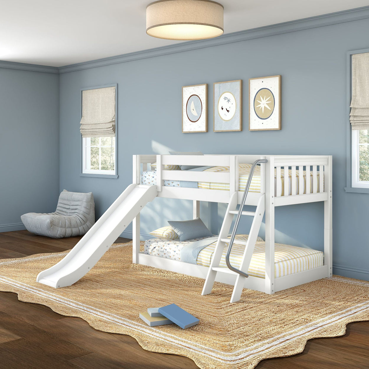 White twin-over-twin wooden bunk bed with slide and ladder in a light blue kids' bedroom, striped bedding, jute rug, beanbag chair and framed wall art