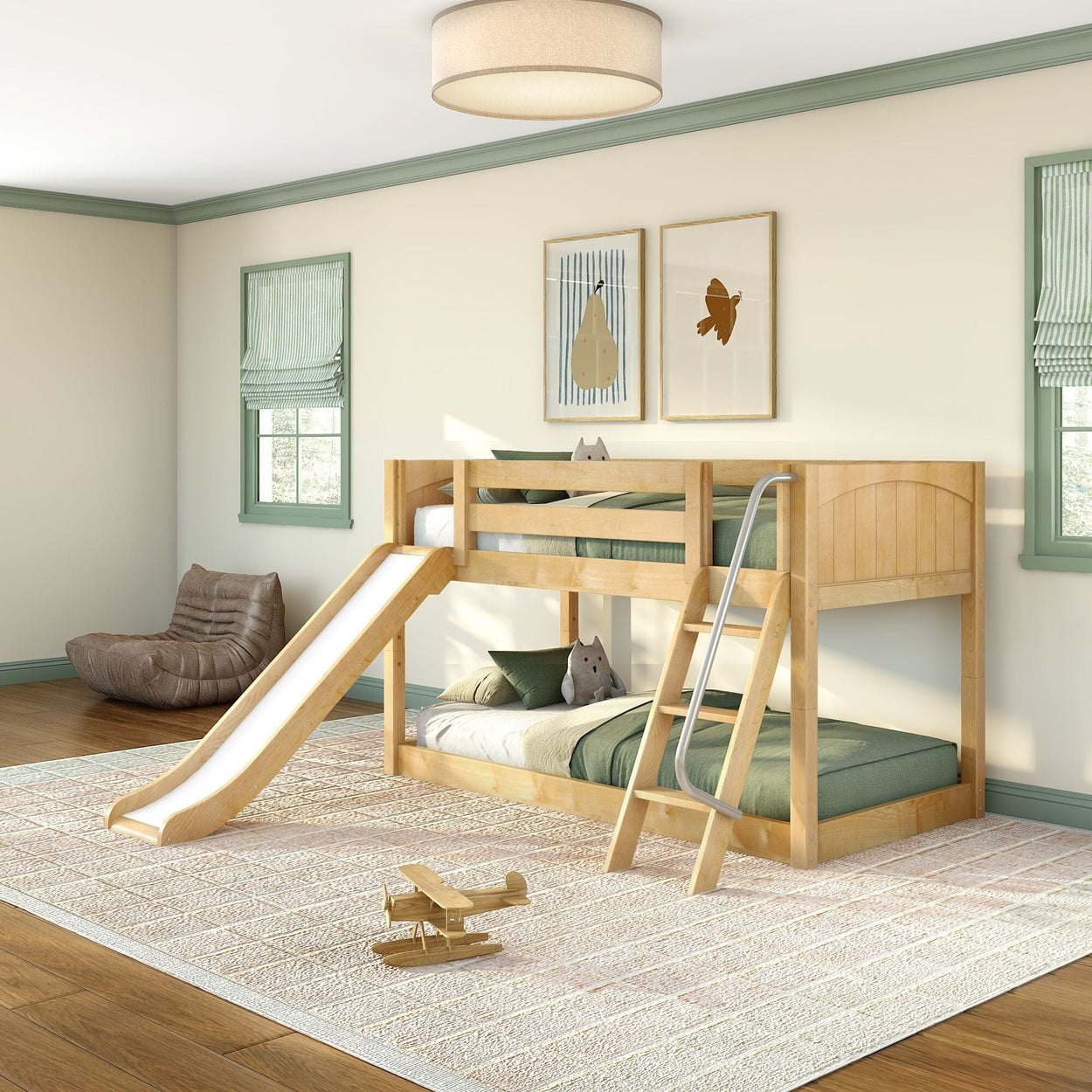 Natural wood kids bunk bed with slide and ladder in bright children's bedroom, green bedding, framed wall art, plush toys and wooden toy airplane on rug